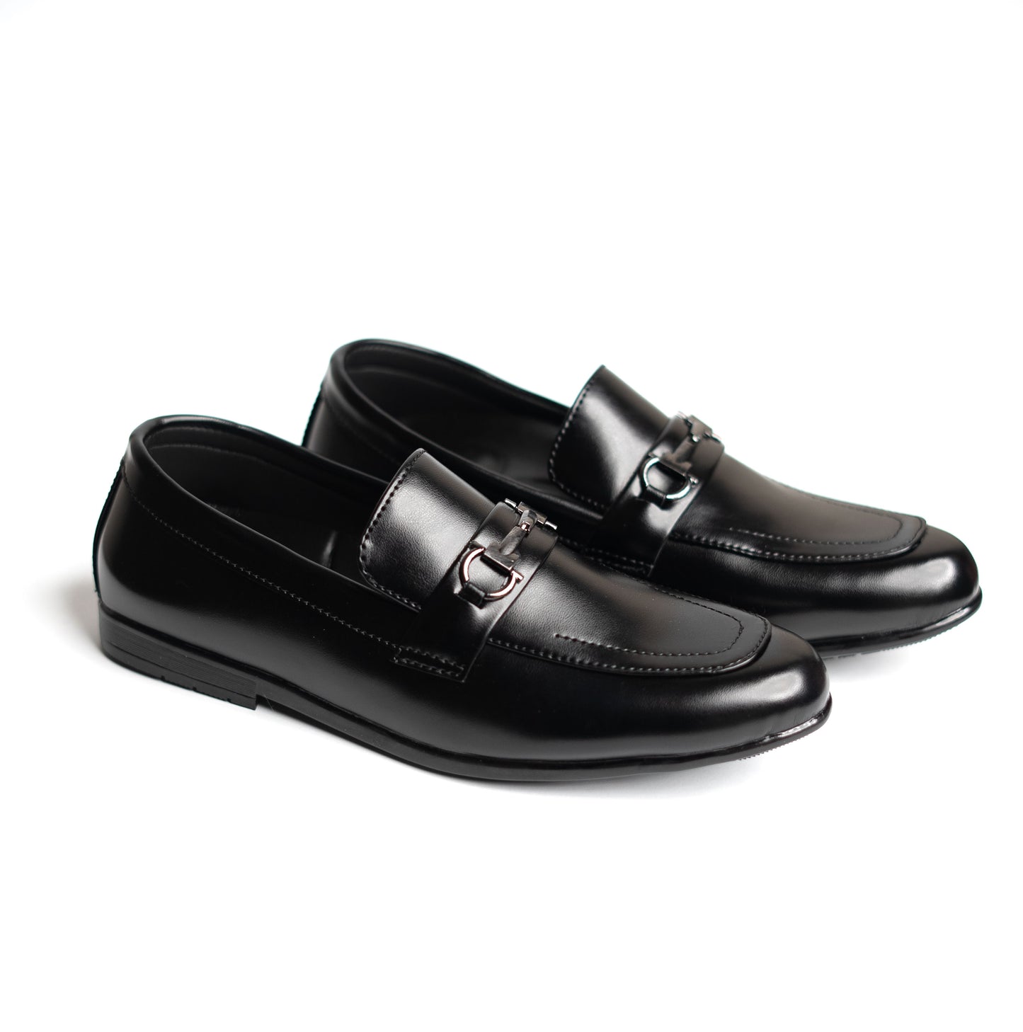 Pair of black loafers with a silver buckle on a white background