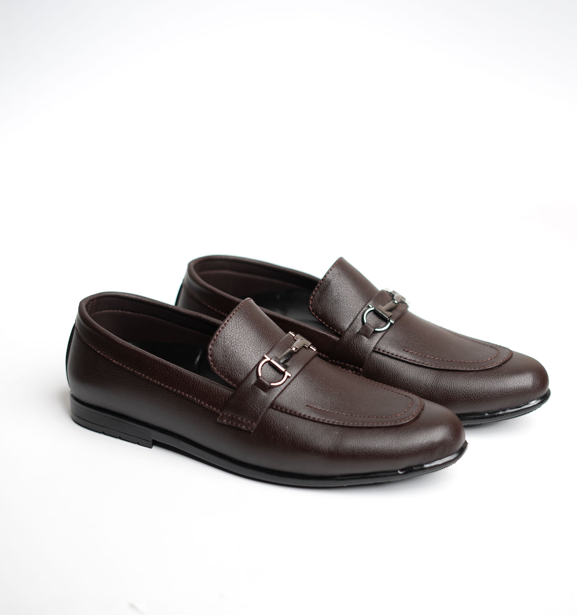 Pair of brown loafers on a white background
