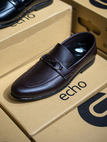 Black leather shoe on an 'echo' branded box