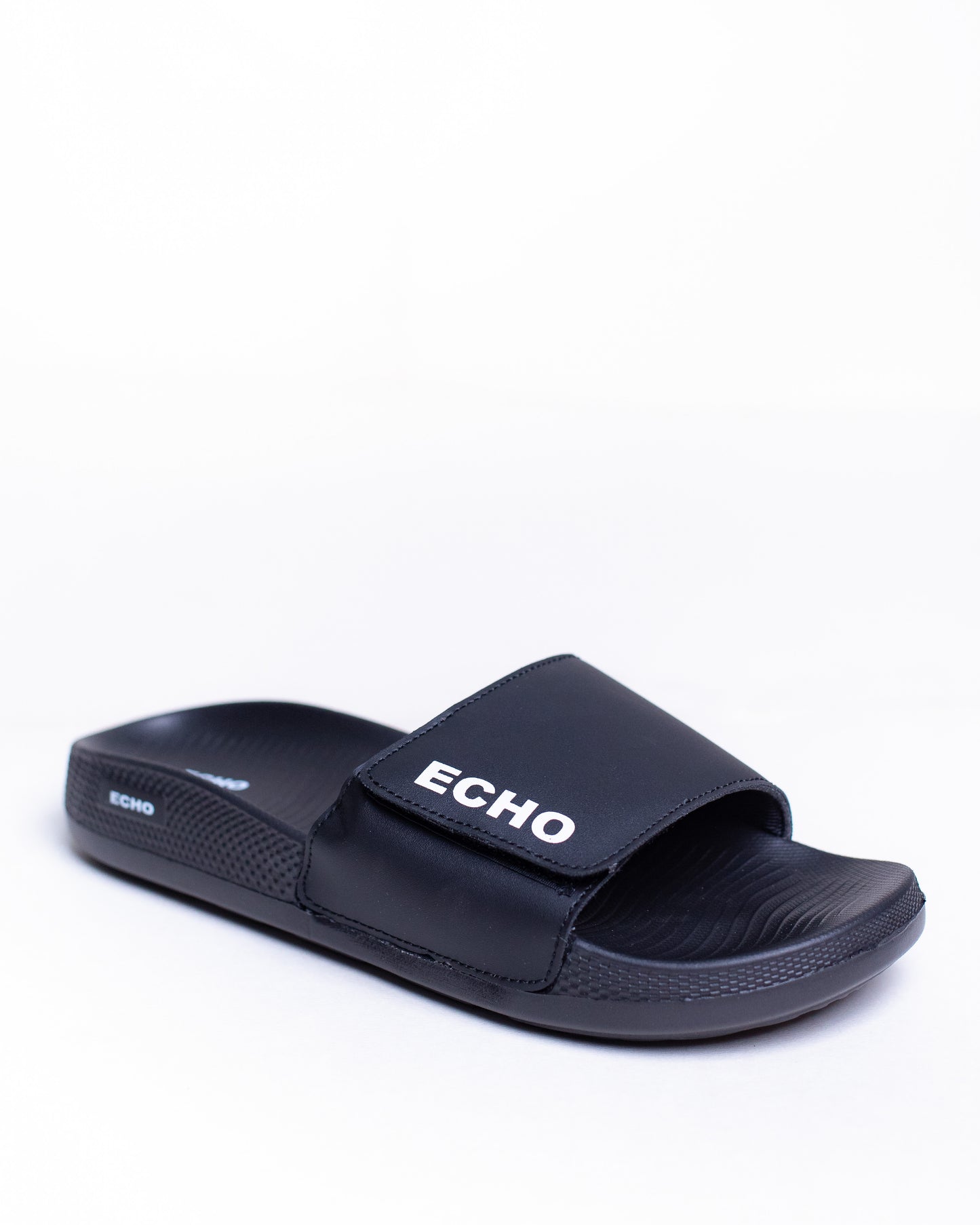 Black slide sandal with 'Echo' branding on a white background