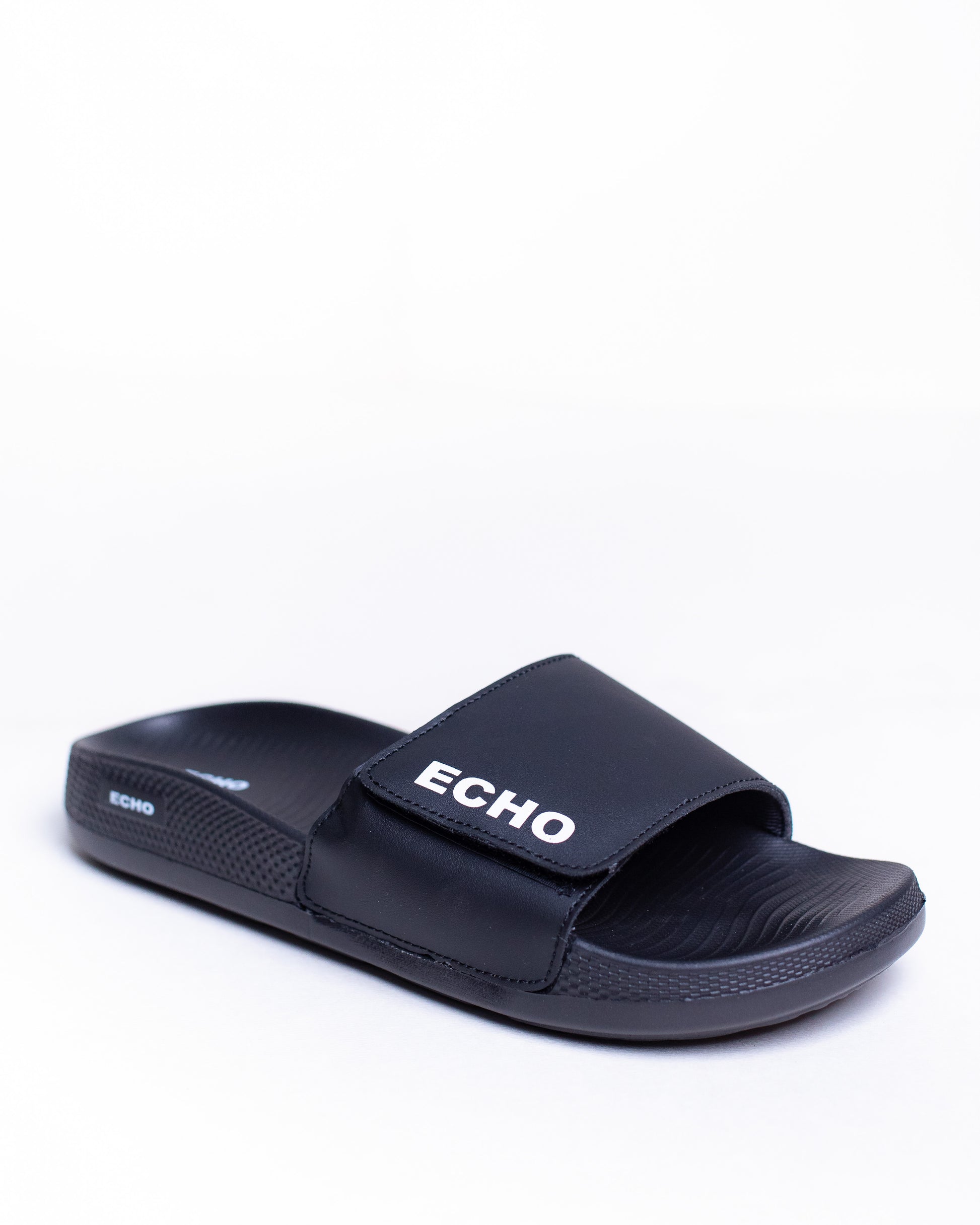 Black slide sandal with 'Echo' branding on a white background