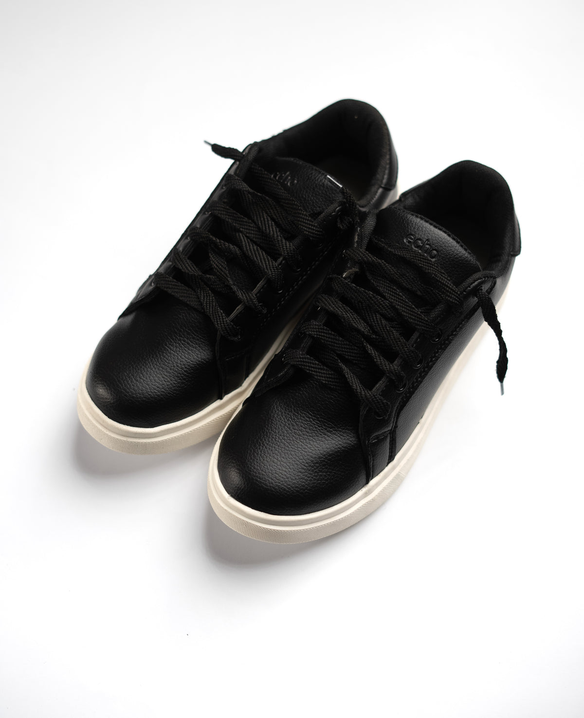 Pair of black sneakers on a white background
