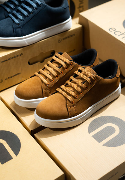 Brown sneakers on Echo brand boxes with a blue sneaker in the background.