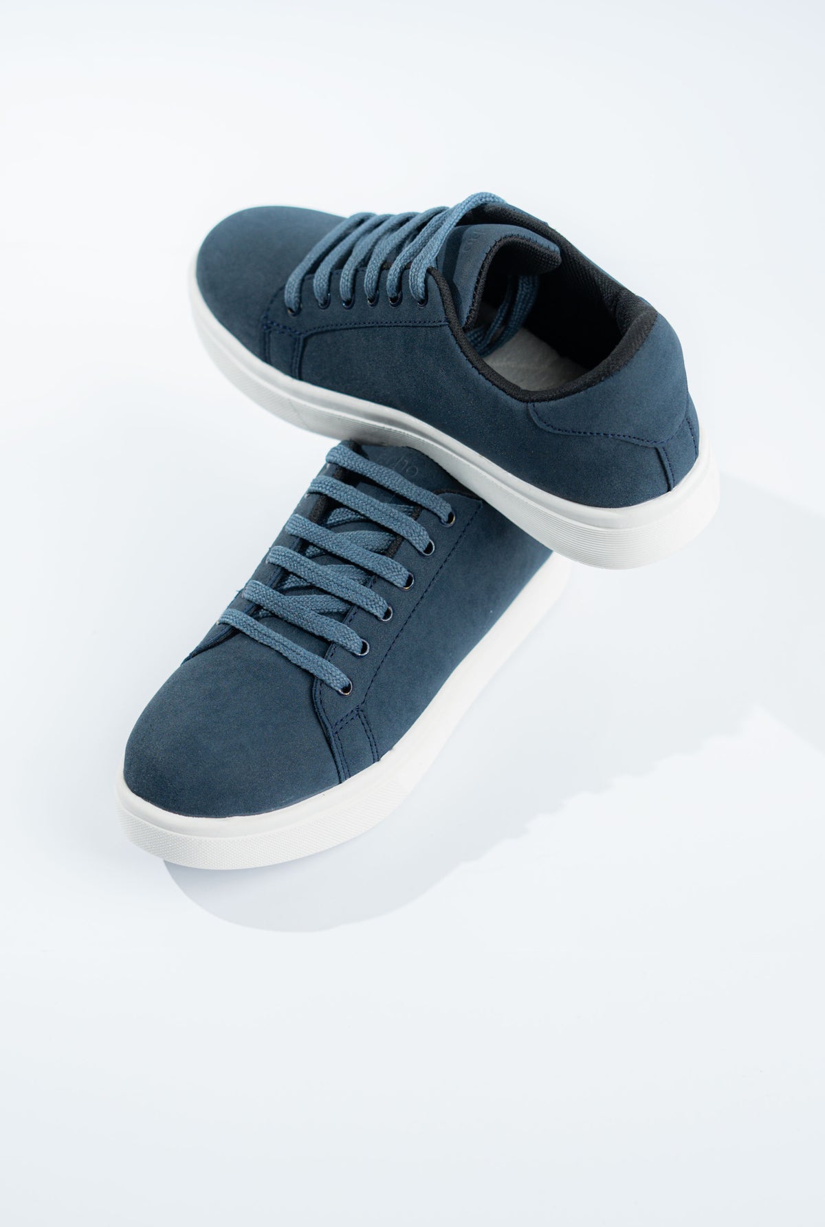 Pair of blue sneakers on a white background