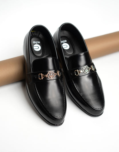 Black leather shoes with gold buckles on a white background