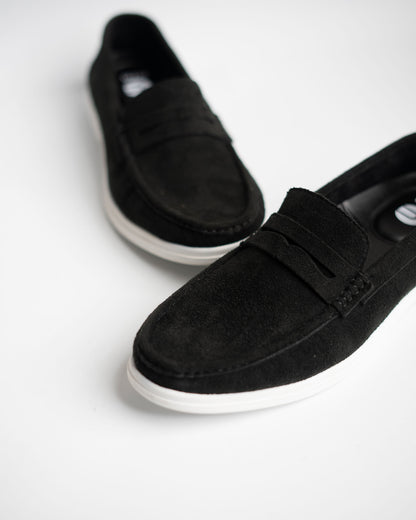 Black loafers on a white background