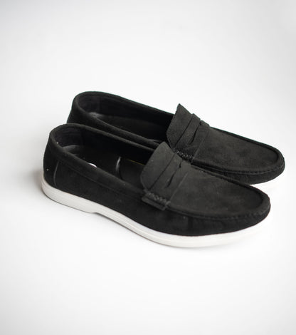 Pair of black loafers on a white background