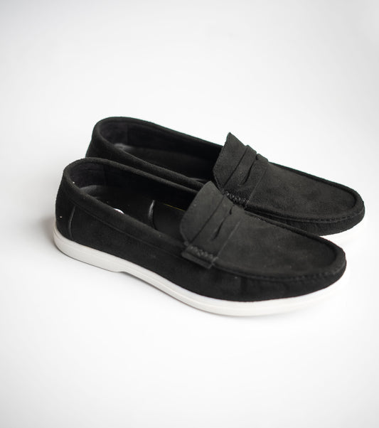 Pair of black loafers on a white background