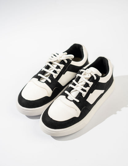 Black and white sneakers on a light gray background