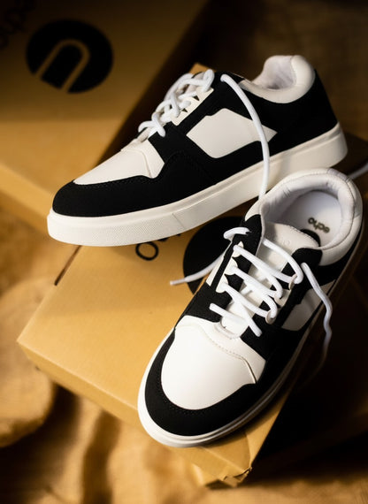 Black and white sneakers on a cardboard box