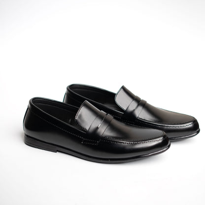 Pair of black loafers on a white background