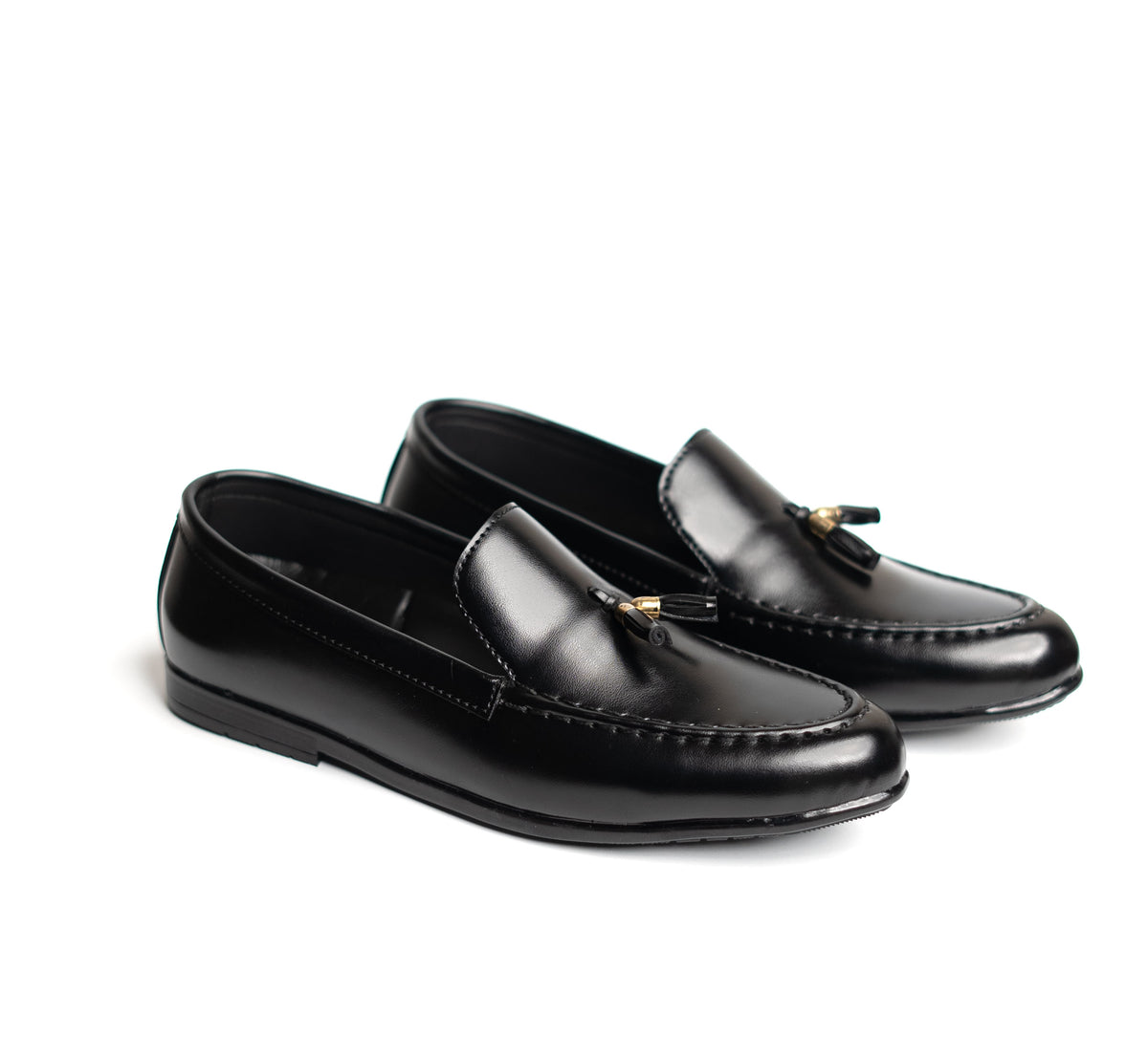 Pair of black loafers with tassels on a white background