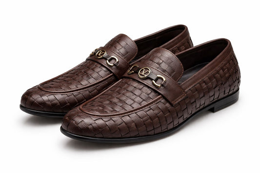 Pair of brown woven loafers with gold buckles on a white background