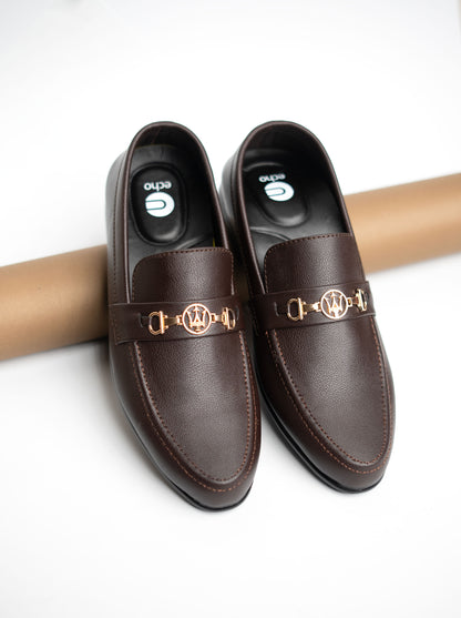 Brown loafers with gold accents on a white background