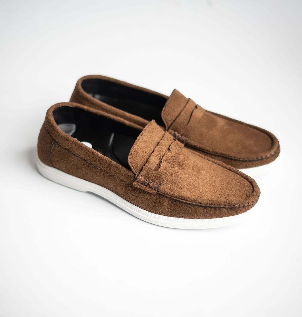 Pair of brown loafers on a white background