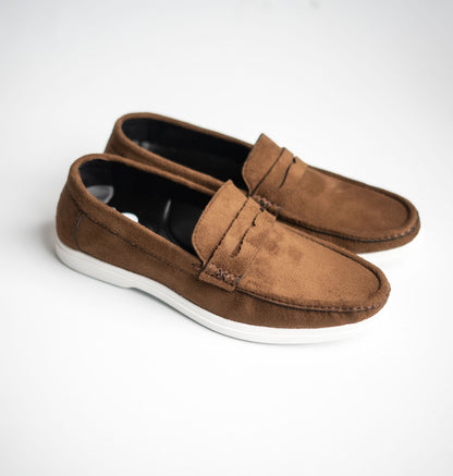 Pair of brown loafers on a white background