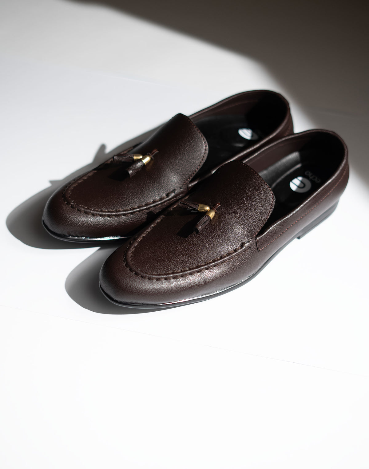Pair of brown loafers on a light background