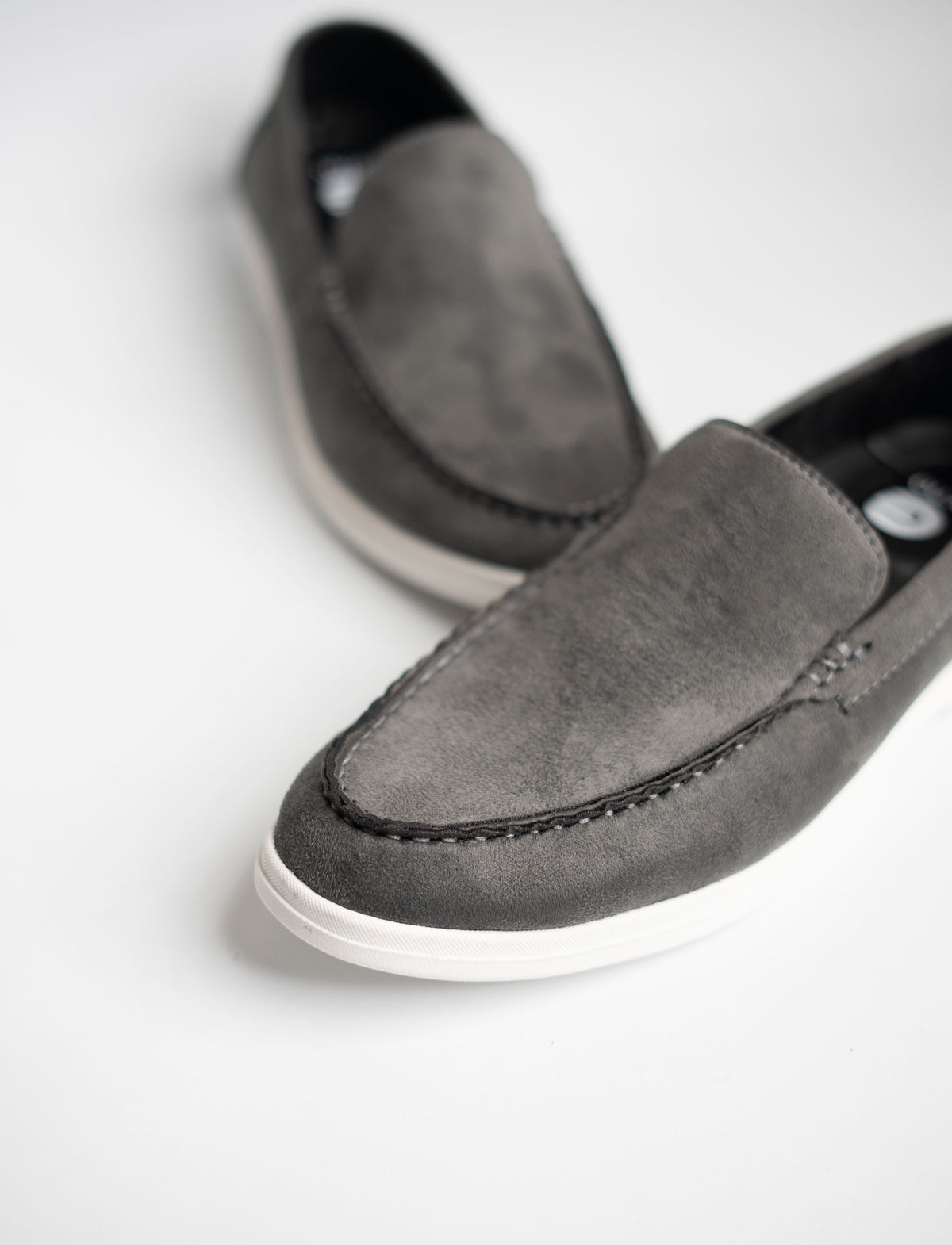 Pair of gray loafers on a white background