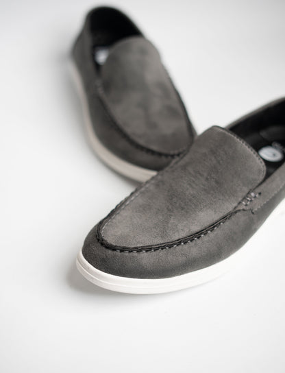 Pair of gray loafers on a white background