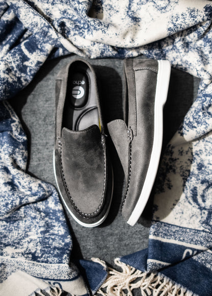 Gray loafers on a textured fabric background