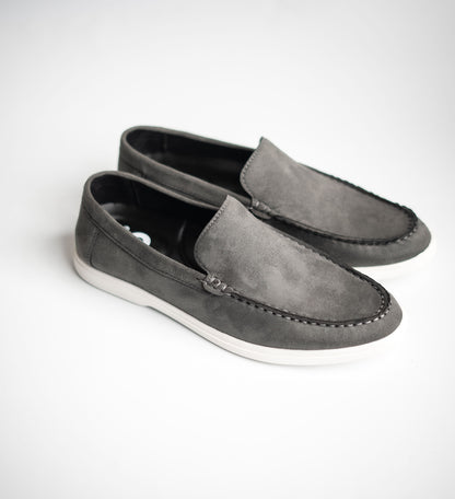 Pair of gray loafers on a white background