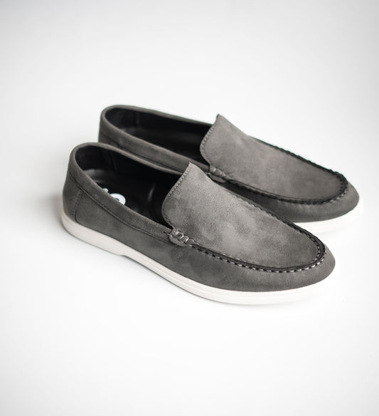 Pair of gray loafers on a white background
