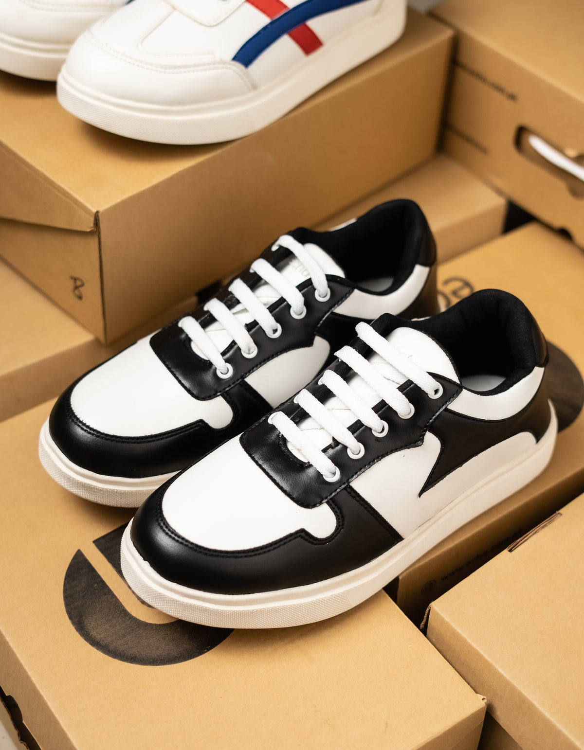 Black and white sneakers on a cardboard box