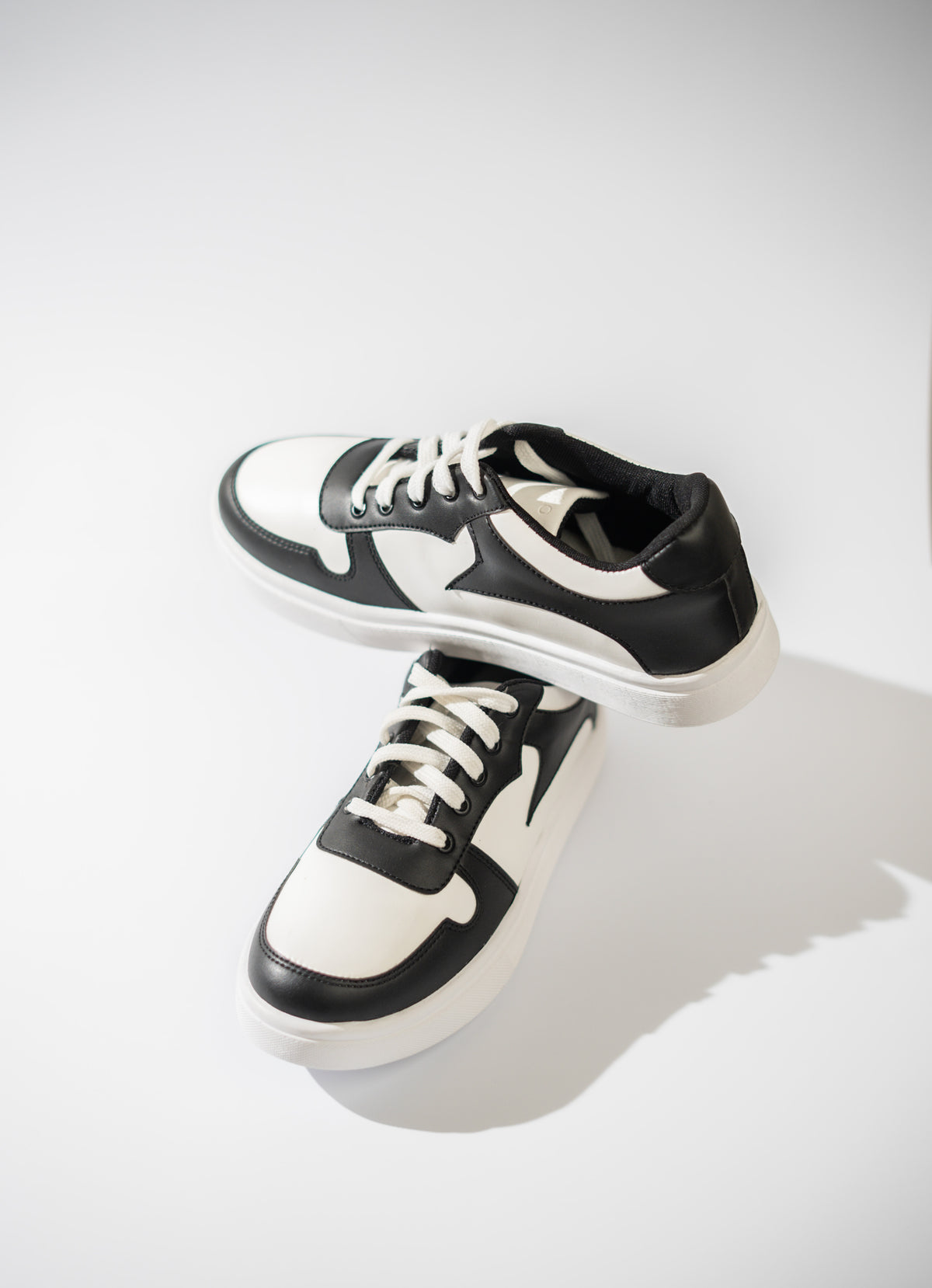 Black and white sneakers on a light gray background