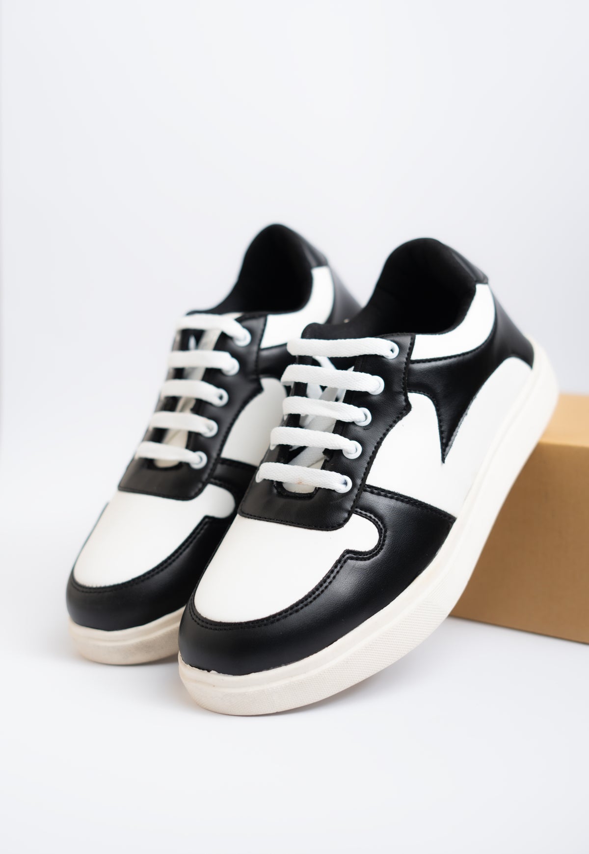 Black and white sneakers on a light gray background