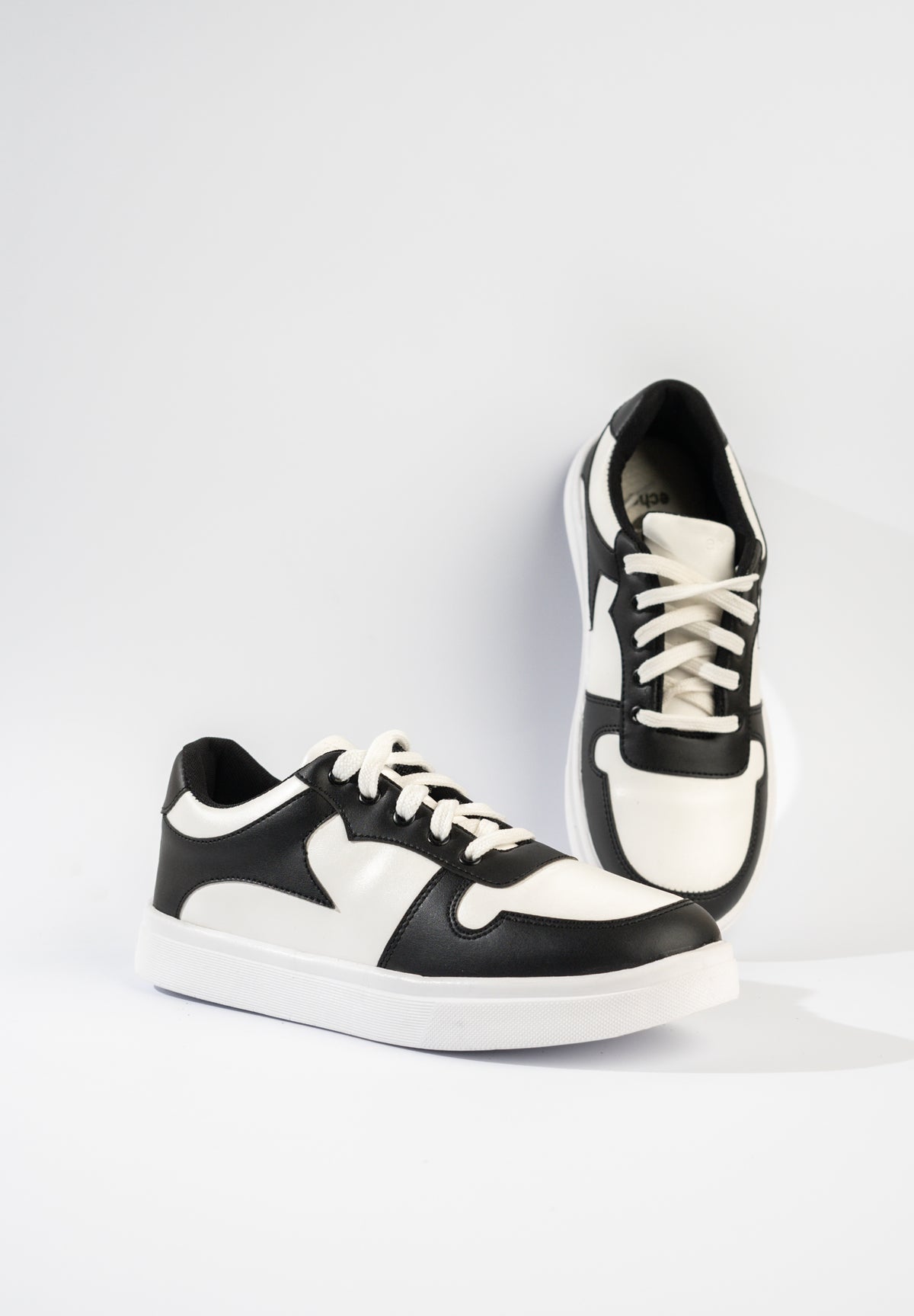 Black and white sneakers on a light gray background