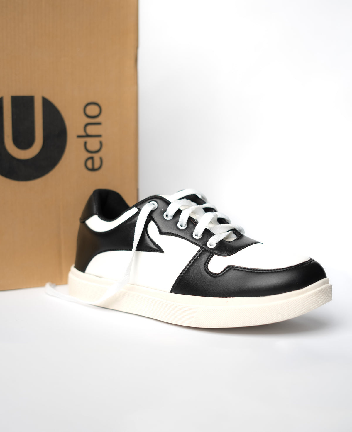 Black and white sneaker with 'echo' box in the background