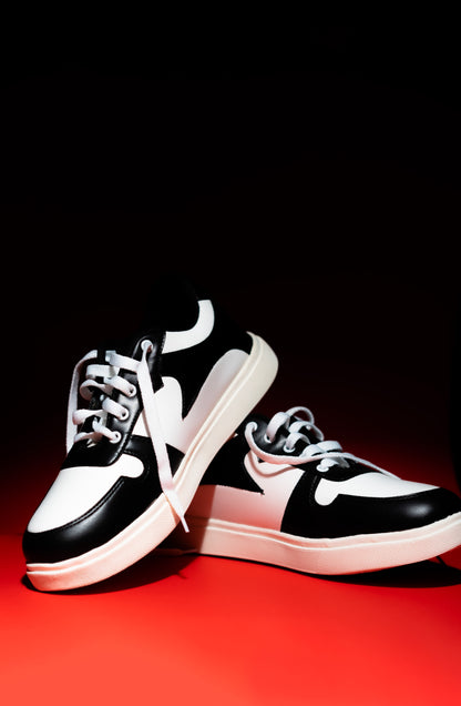 Black and white sneakers on a red and black background