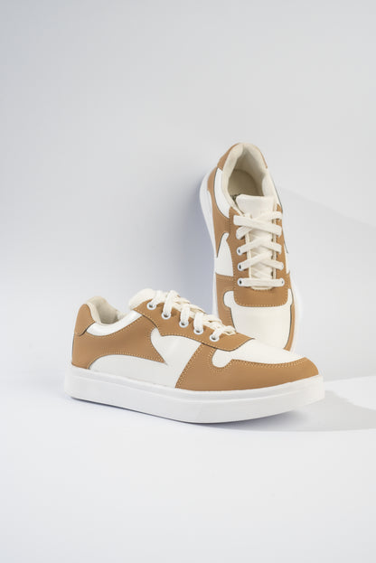 Pair of tan and white sneakers on a light gray background