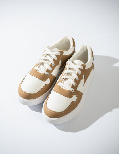 Pair of cream and white sneakers on a light gray background