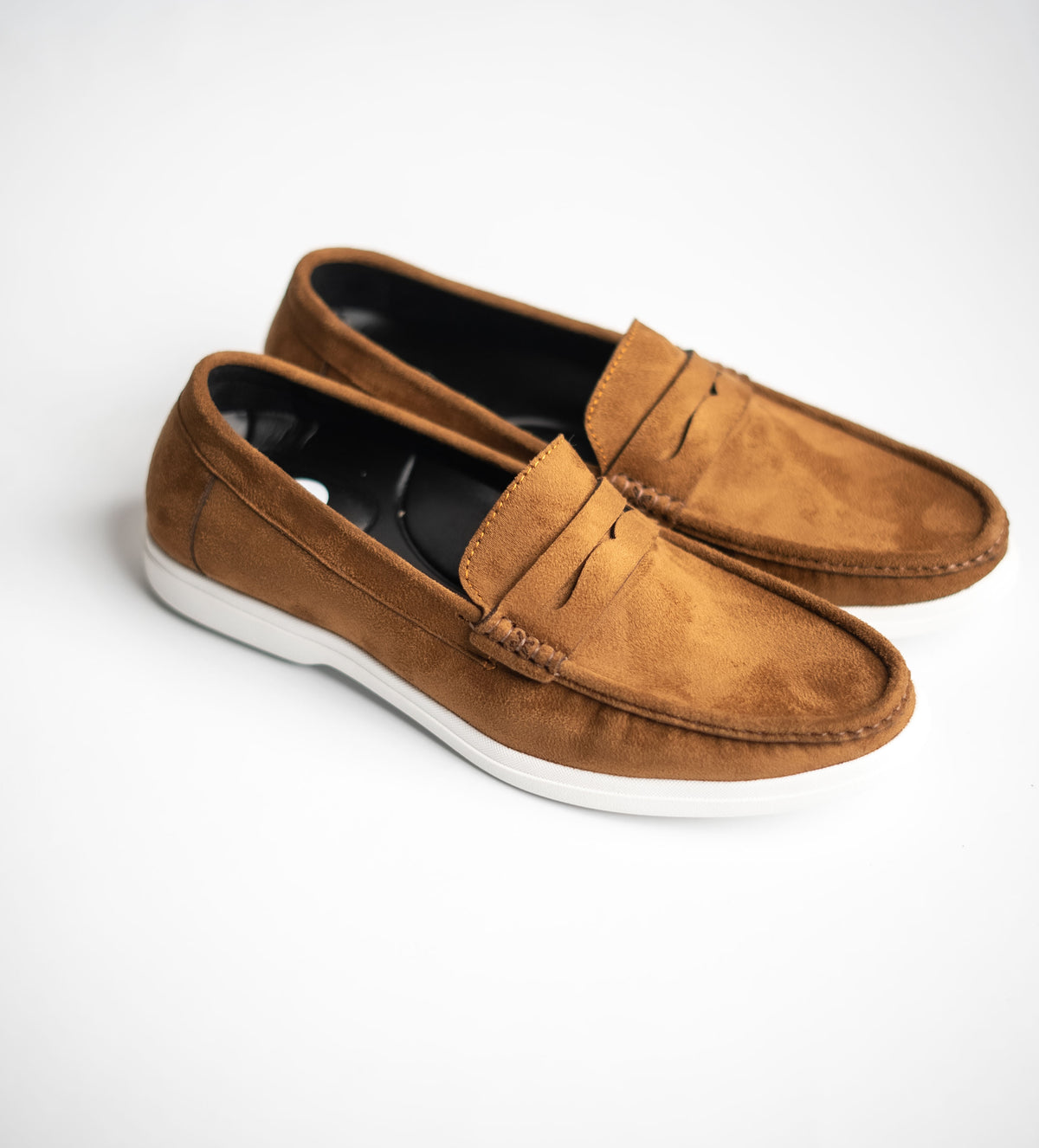 Pair of brown loafers on a white background