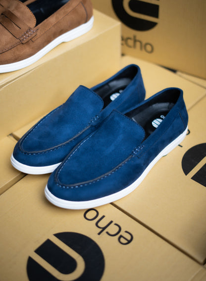 Blue loafers on a cardboard box with 'echo' branding