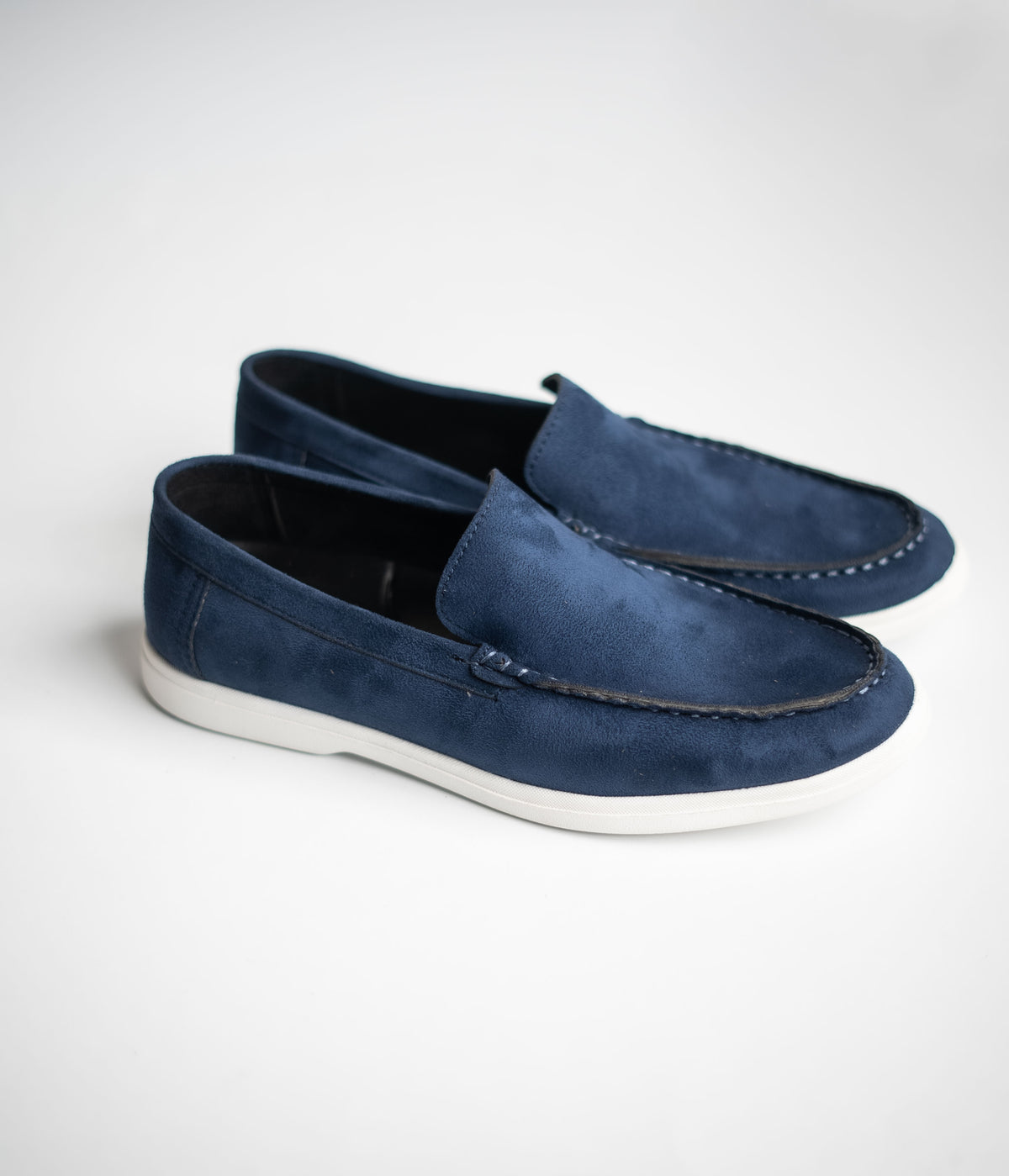 Pair of blue loafers on a white background