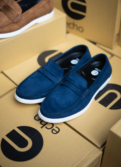 Blue loafers on a cardboard box with 'echo' branding