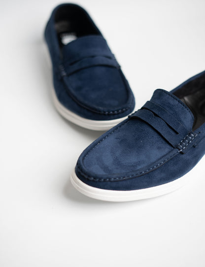Pair of blue loafers on a white background