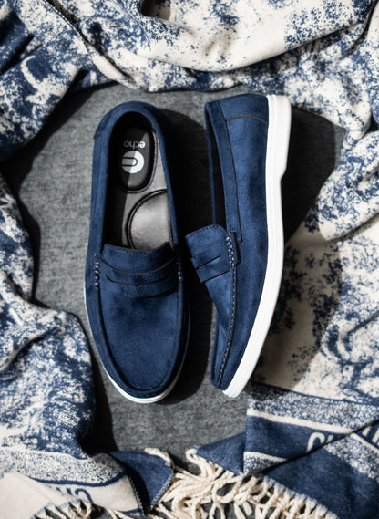 Pair of blue loafers on a textured fabric background