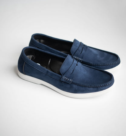 Pair of blue loafers on a white background
