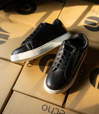 Black sneakers on cardboard boxes with 'echo' branding