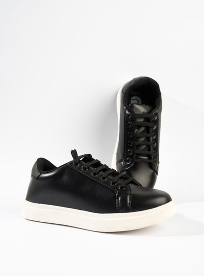 Black high-top sneaker with white sole on a light gray background