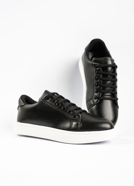 Pair of black sneakers on a white background