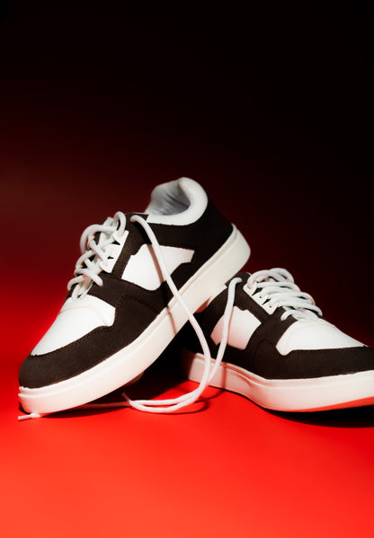 brown and white sneakers on a red background