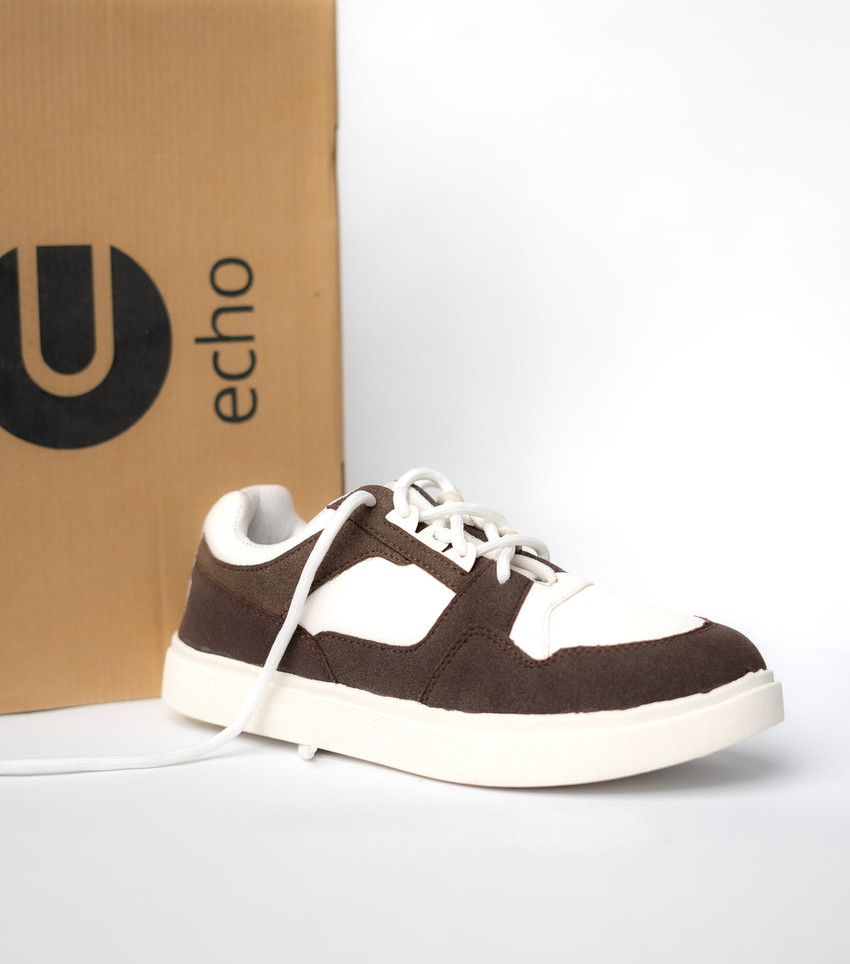 Brown and white sneaker with 'echo' branded box in the background