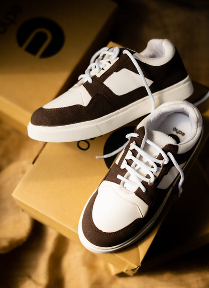 Pair of brown and white sneakers on a cardboard box