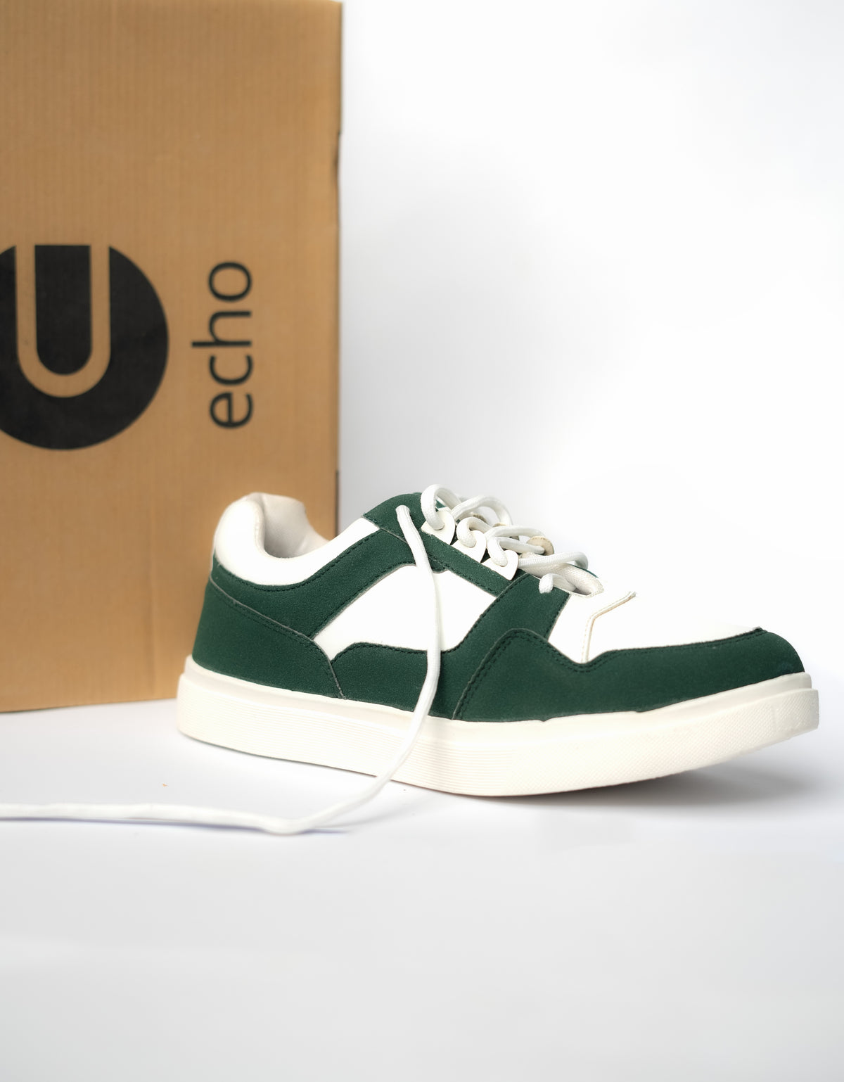 Green and white sneaker in front of an 'echo' branded box on a white background