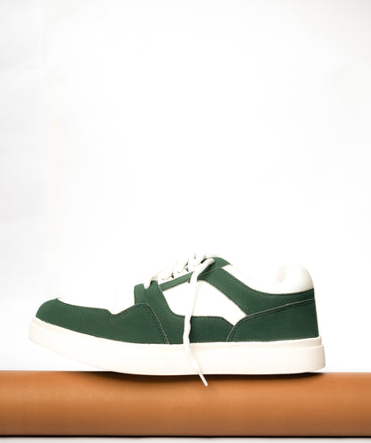 Green sneaker with white laces on a white background