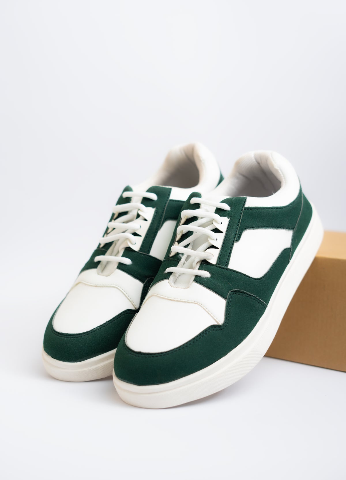 Green and white sneakers on a light gray background